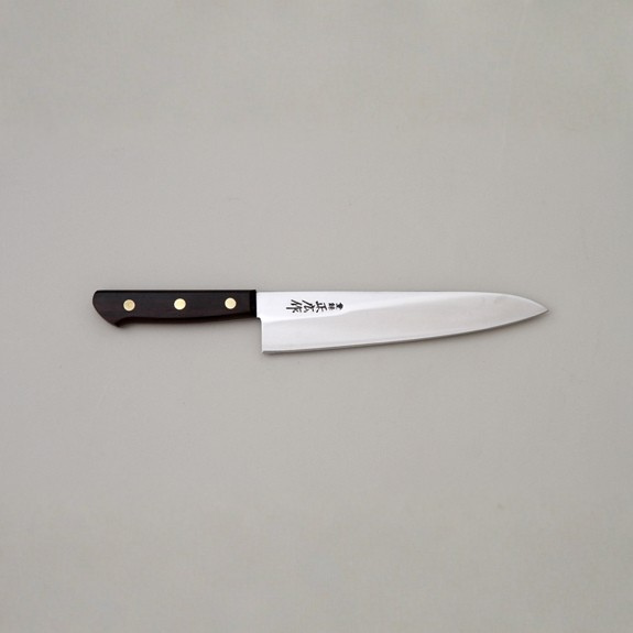 Knife with a black handle on a gray background