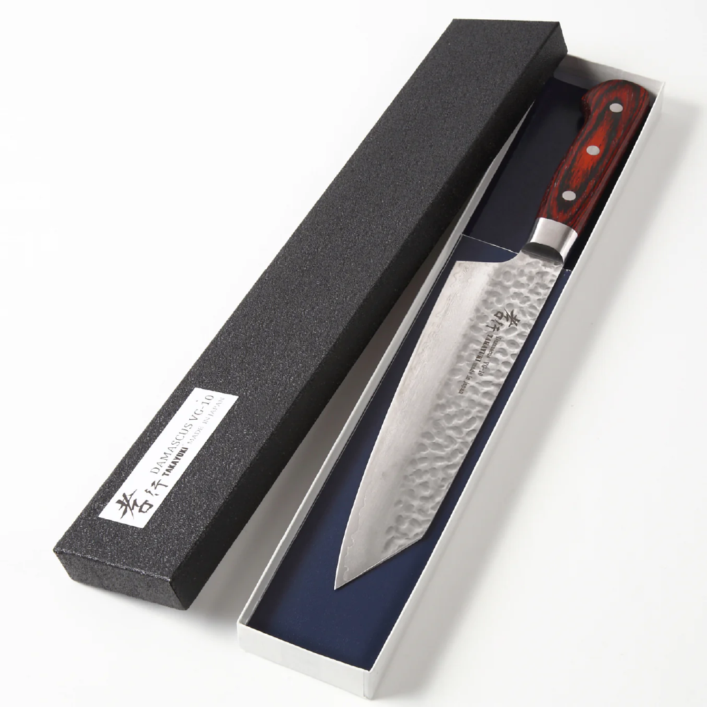 Japanese chef's knife with a wooden handle in a black box on a white background