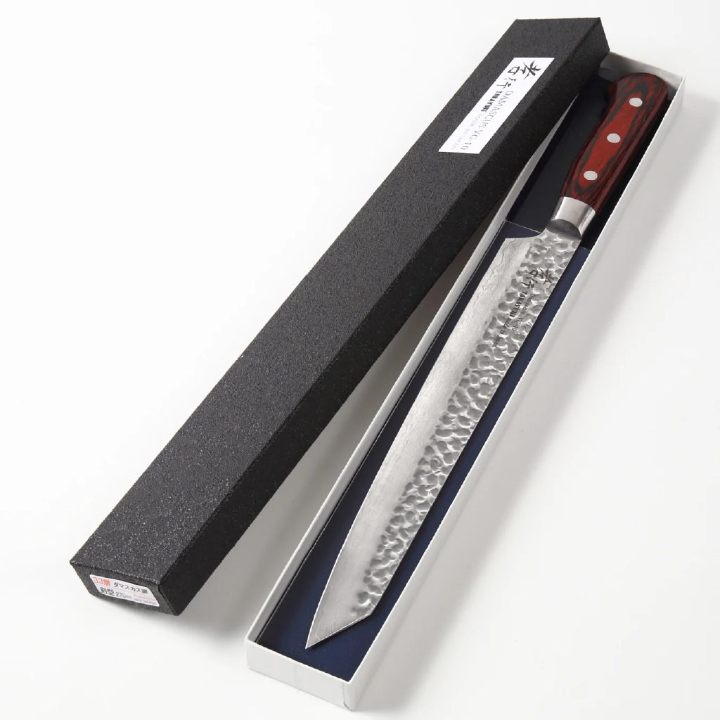 Japanese Yanagiba knife with a handle in an open black box on a white background